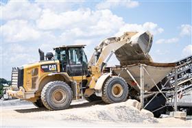 Rahns Concrete: A Caterpillar 966M loads concrete sand into one of the hoppers at a portable ready-mix concrete plant.