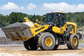 Rahns Concrete: A Rahns Concrete Komatsu WA-320 loader prepares to load a hopper with aggregate.