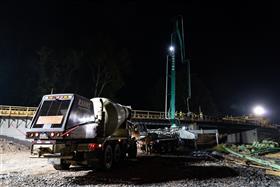 Rahns Concrete: A Rahns Concrete front discharge mixer truck feeds product into a pump truck for a bridge deck pour. 