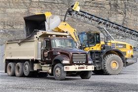 Rahns Concrete: A Mack triaxle dump truck being loaded with stone.